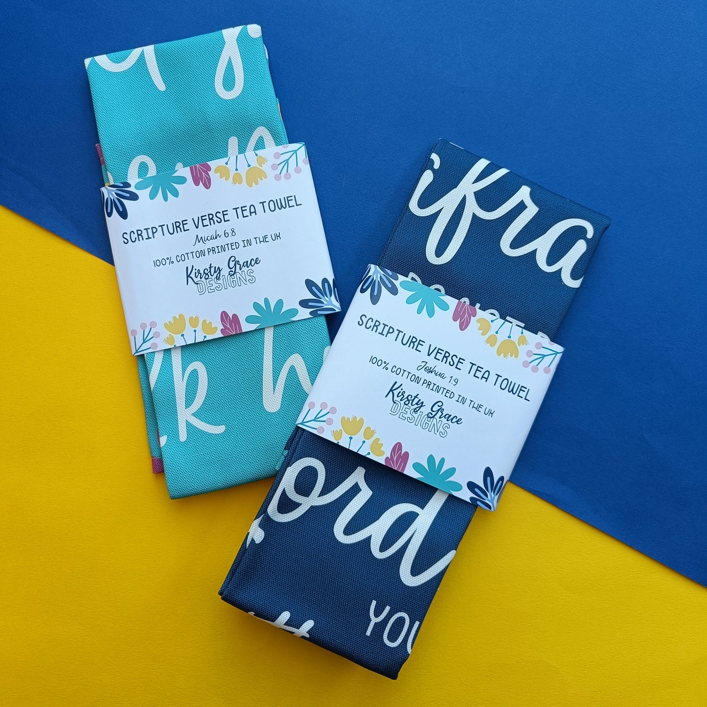 Two tea towels with colorful text on a blue and yellow background