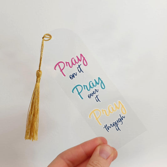Decorative tassel with colorful text on a white background