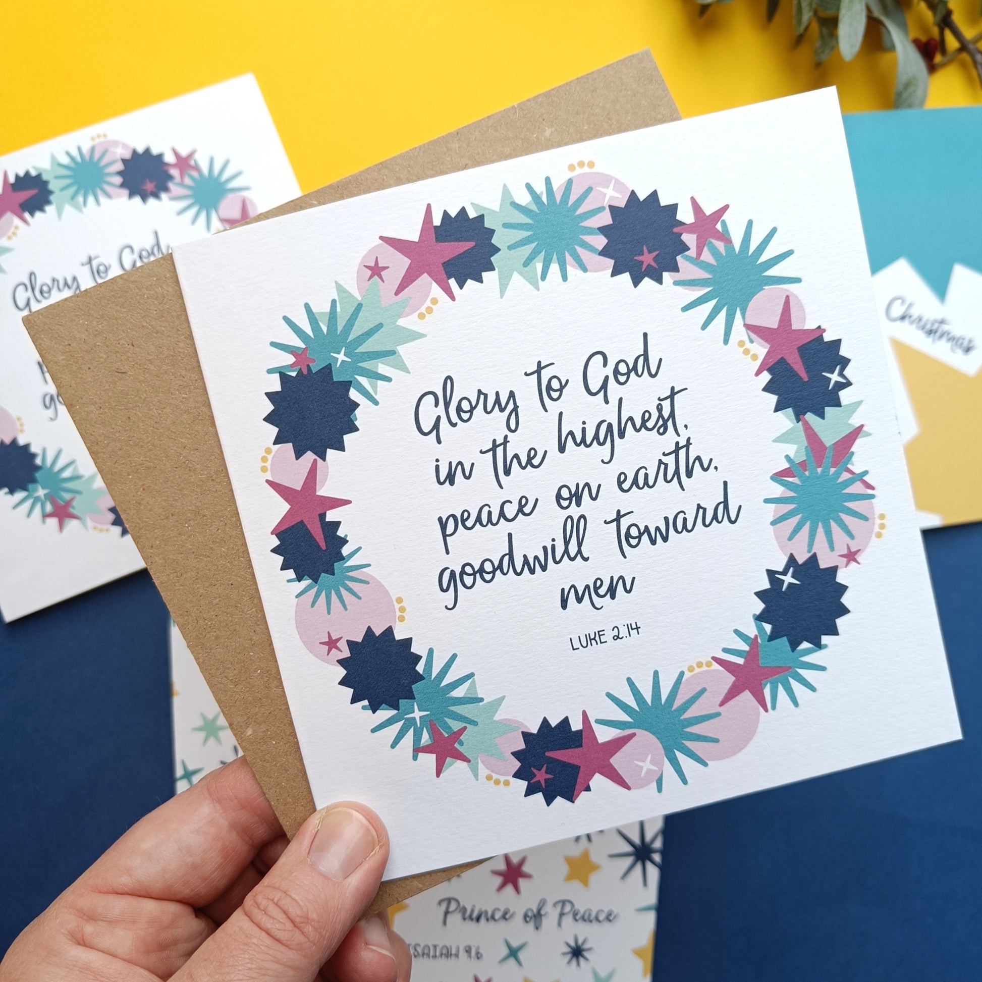 Card with floral design and text held by a hand on a colorful background