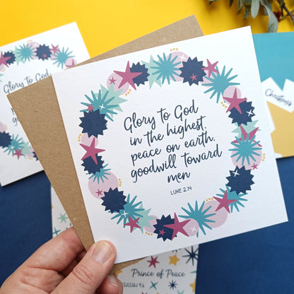 Card with floral design and text held by a hand on a colorful background